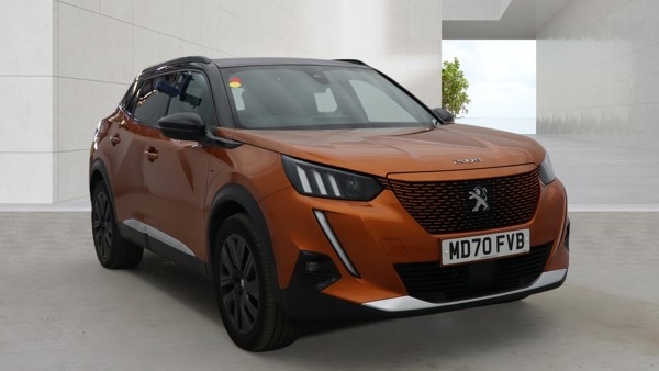 Peugeot e-2008 Orange Peugeot SUV parked in a modern setting with a simple background.